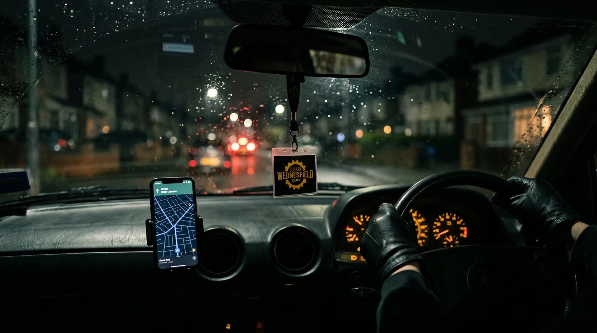 A Wednesfield Cars driver on a night shift, with the booking app on the dashboard phone